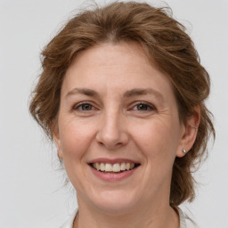 Joyful white adult female with medium  brown hair and grey eyes