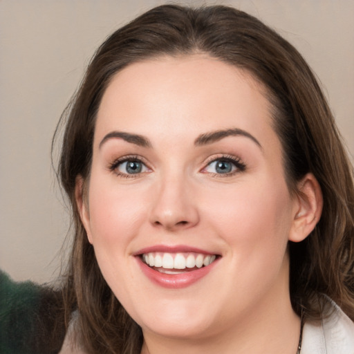 Joyful white young-adult female with medium  brown hair and green eyes