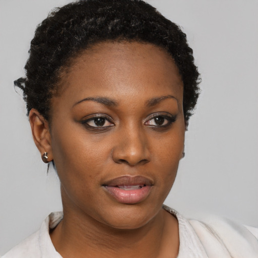 Joyful black young-adult female with short  brown hair and brown eyes