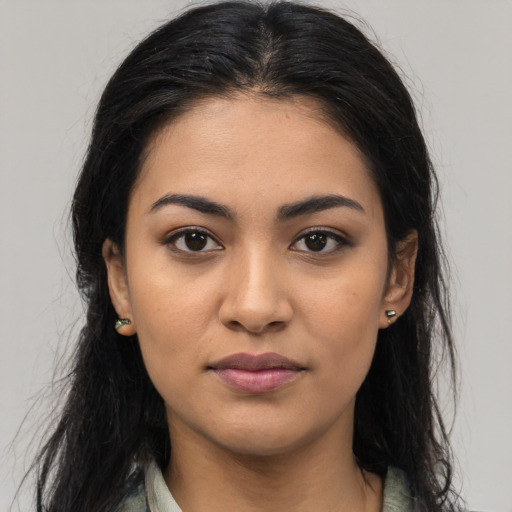 Joyful latino young-adult female with long  black hair and brown eyes