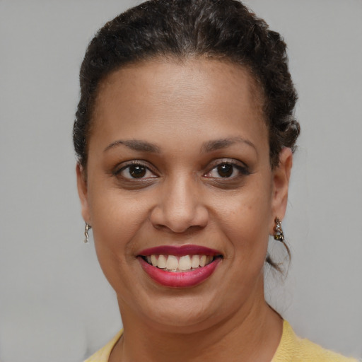 Joyful black young-adult female with short  brown hair and brown eyes