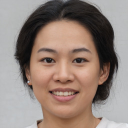 Joyful asian young-adult female with medium  brown hair and brown eyes