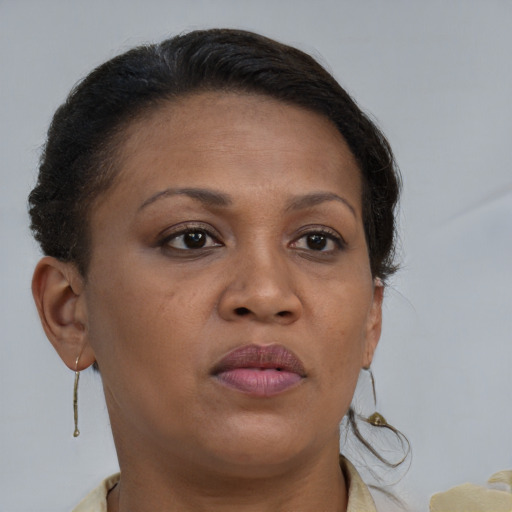 Joyful black adult female with short  brown hair and brown eyes