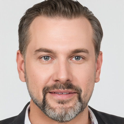 Joyful white adult male with short  brown hair and brown eyes