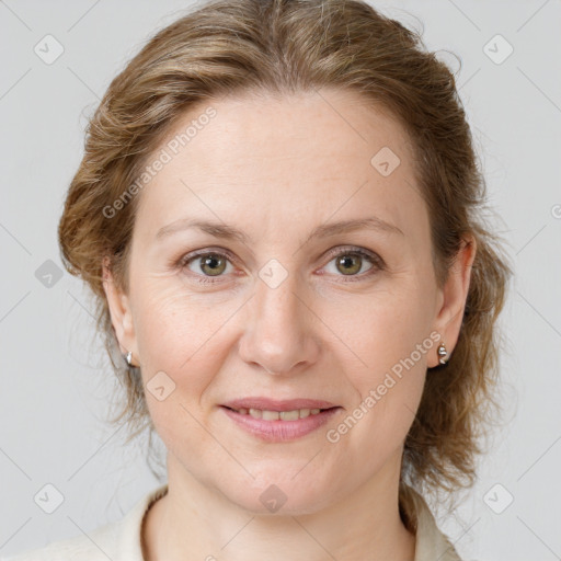 Joyful white adult female with medium  brown hair and grey eyes