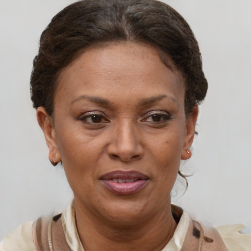 Joyful black adult female with short  brown hair and brown eyes