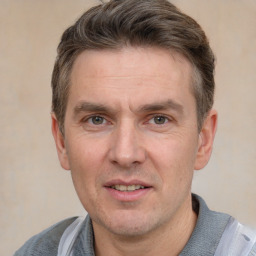 Joyful white adult male with short  brown hair and grey eyes