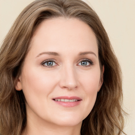 Joyful white young-adult female with long  brown hair and green eyes