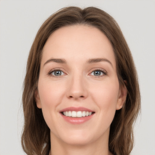 Joyful white young-adult female with long  brown hair and grey eyes