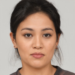 Joyful asian young-adult female with medium  brown hair and brown eyes