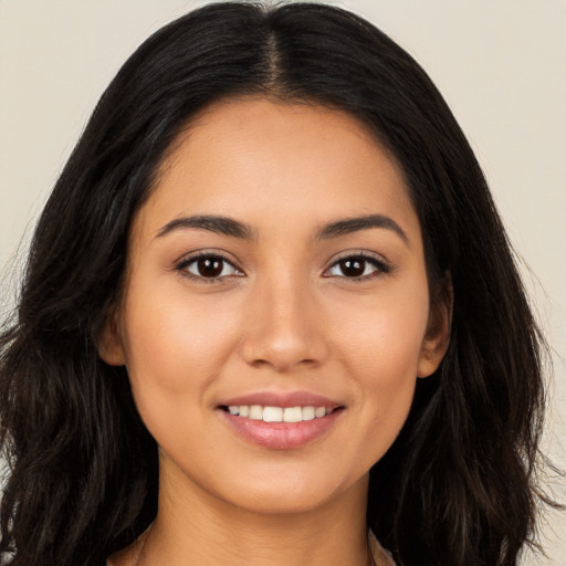 Joyful white young-adult female with long  black hair and brown eyes