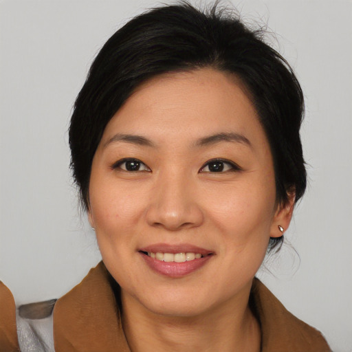 Joyful asian young-adult female with medium  black hair and brown eyes