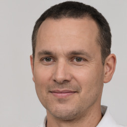 Joyful white adult male with short  brown hair and brown eyes