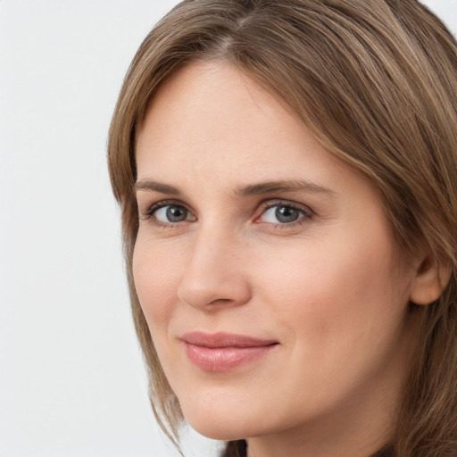 Joyful white young-adult female with long  brown hair and grey eyes