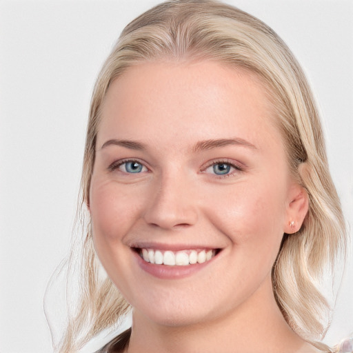 Joyful white young-adult female with long  brown hair and blue eyes