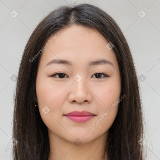 Joyful asian young-adult female with long  brown hair and brown eyes