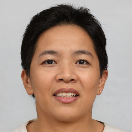 Joyful asian adult female with short  brown hair and brown eyes