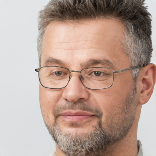 Joyful white middle-aged male with short  brown hair and brown eyes