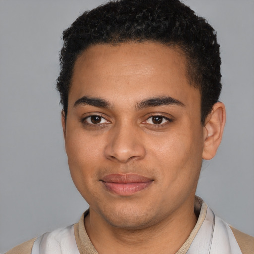 Joyful latino young-adult male with short  black hair and brown eyes
