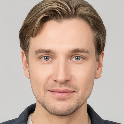 Joyful white young-adult male with short  brown hair and grey eyes