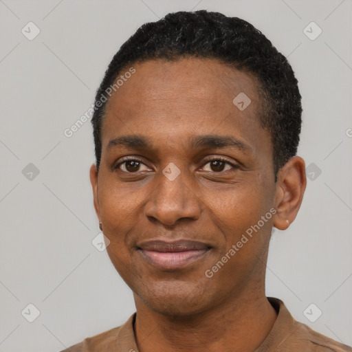 Joyful black young-adult male with short  black hair and brown eyes