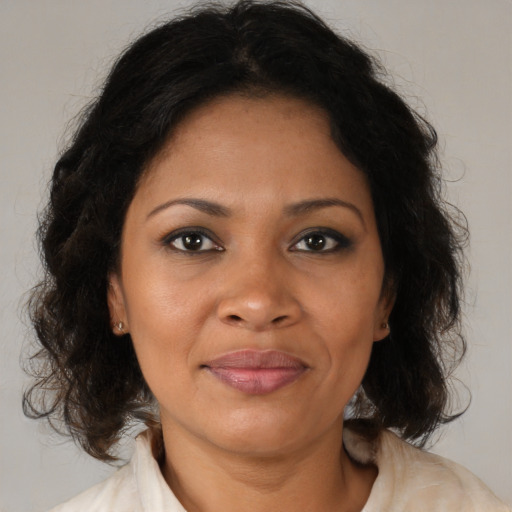 Joyful black adult female with medium  brown hair and brown eyes