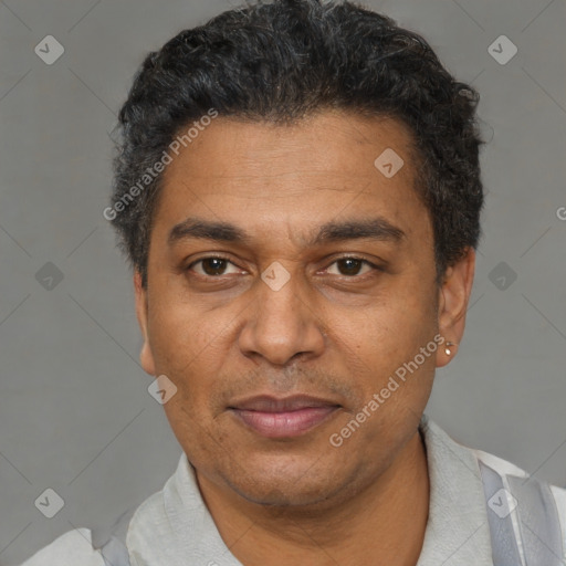 Joyful black adult male with short  black hair and brown eyes