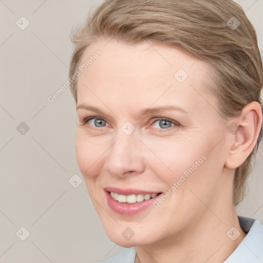 Joyful white young-adult female with medium  brown hair and blue eyes