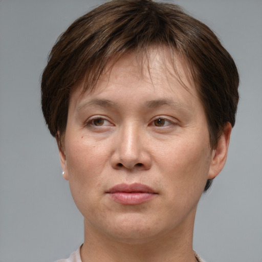 Joyful asian adult female with short  brown hair and grey eyes