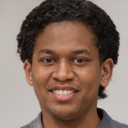 Joyful latino young-adult male with short  brown hair and brown eyes