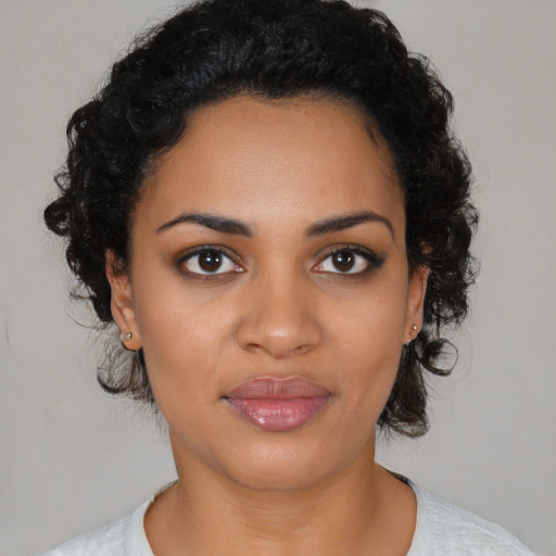 Joyful black young-adult female with medium  black hair and brown eyes