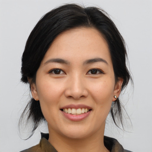 Joyful asian young-adult female with medium  black hair and brown eyes