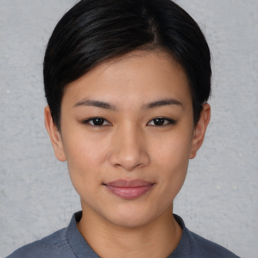 Joyful asian young-adult female with short  black hair and brown eyes