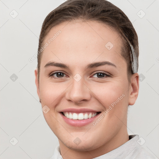 Joyful white young-adult female with short  brown hair and brown eyes