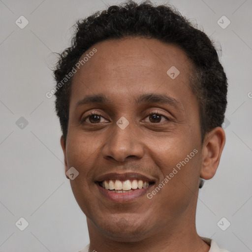 Joyful black young-adult male with short  black hair and brown eyes