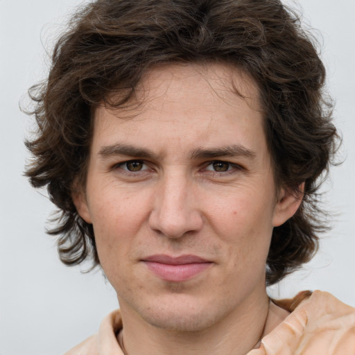 Joyful white adult male with medium  brown hair and brown eyes