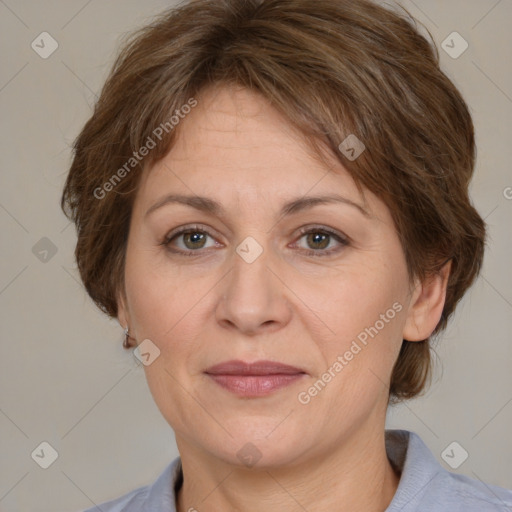 Joyful white adult female with medium  brown hair and grey eyes