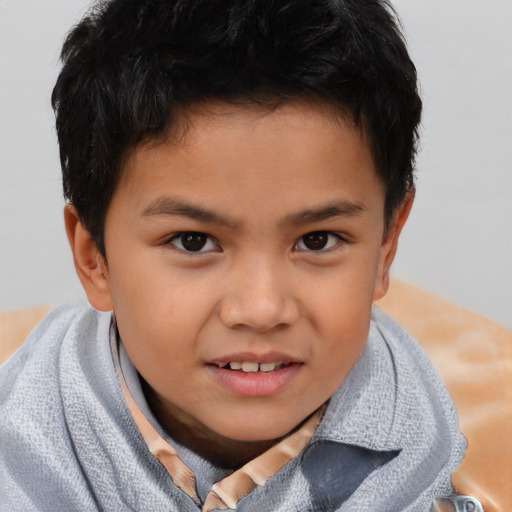 Joyful asian child male with short  brown hair and brown eyes