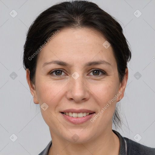 Joyful white adult female with short  brown hair and grey eyes