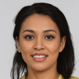 Joyful latino young-adult female with medium  brown hair and brown eyes