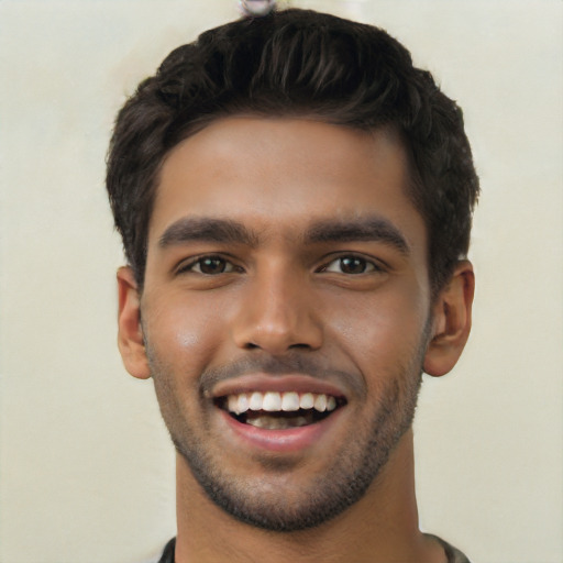 Joyful white young-adult male with short  black hair and brown eyes