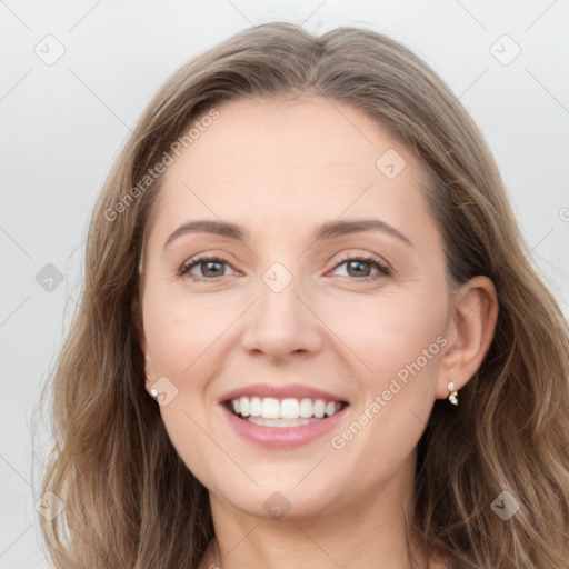 Joyful white young-adult female with long  brown hair and grey eyes