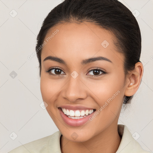 Joyful latino young-adult female with long  brown hair and brown eyes