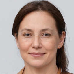 Joyful white adult female with medium  brown hair and grey eyes