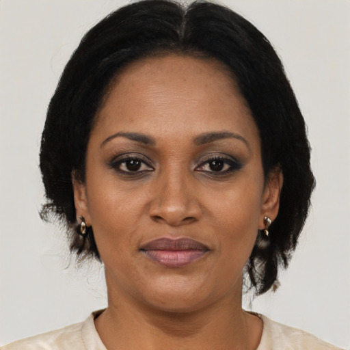 Joyful black adult female with medium  brown hair and brown eyes