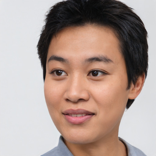 Joyful asian young-adult female with short  brown hair and brown eyes