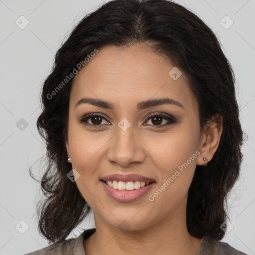 Joyful latino young-adult female with long  brown hair and brown eyes