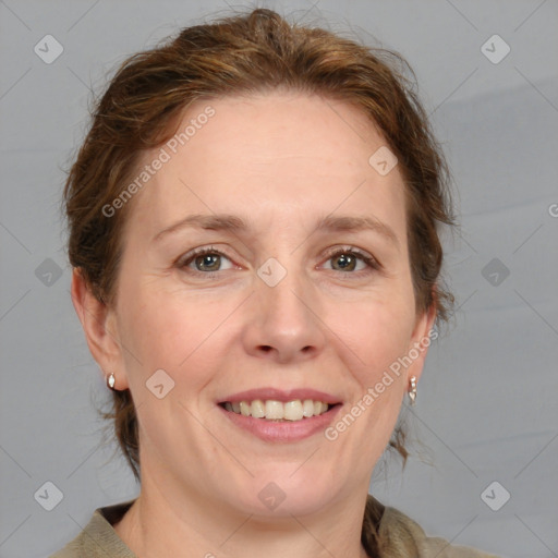 Joyful white adult female with medium  brown hair and blue eyes