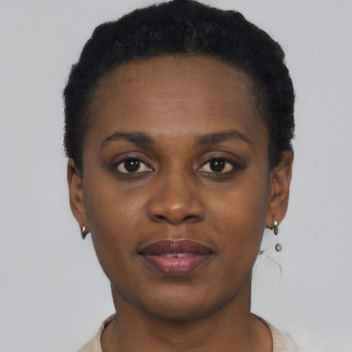 Joyful black young-adult female with short  black hair and brown eyes