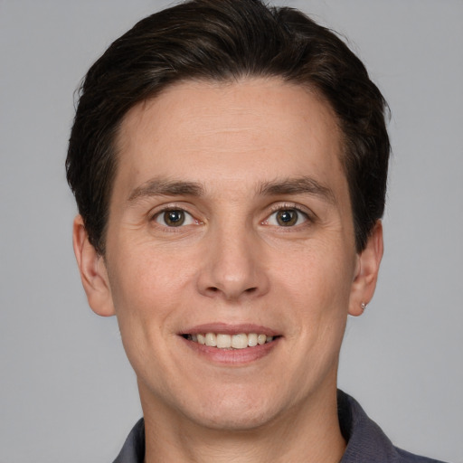 Joyful white adult male with short  brown hair and grey eyes